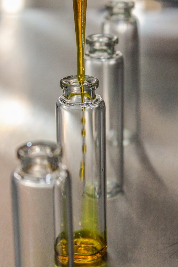 clear glass bottle with yellow liquid